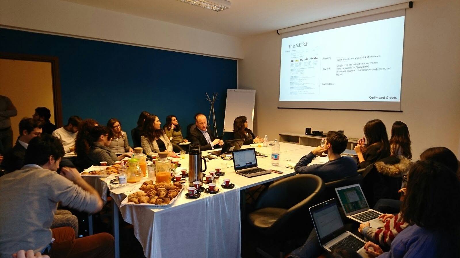 Workshop i Milano med deltagare och projicerad SERP-slide